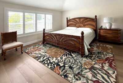 Before, the rug competes with the bed and looks busy, master bedroom of courtyard villa model, Interior Design - by Ruth Dyer.