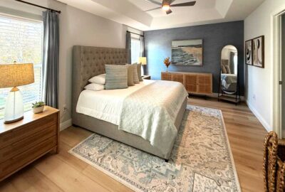 Blue grass cloth wall looks inviting, Master bedroom of a Zinnia model, Interior Design - in the Villages of Florida.