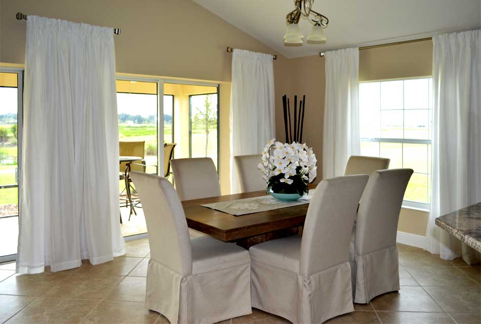 Long side panels hung high complement to view beyond - Interior Design - in the Villages of Florida.