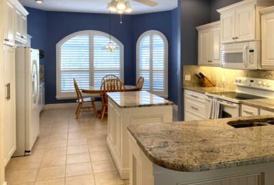 White Kitchen with granite backsplas, wall color make the statement, Home Décor by Ruth Dyer - in the Villages of Florida.