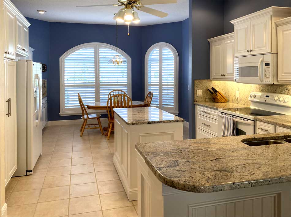 White Kitchen with granite backsplas, wall color make the statement, Home Décor by Ruth Dyer - in the Villages of Florida.