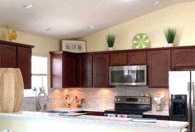 Before, yellow walls, a few things above cabinets, Kitchen of Siesta Model, Interior Design - by Ruth Dyer.