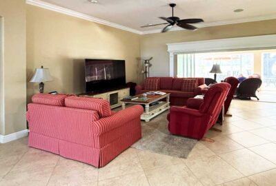 Red sofas commanded all the attention, living room of a Lantana model, Interior Design - by Ruth Dyer.
